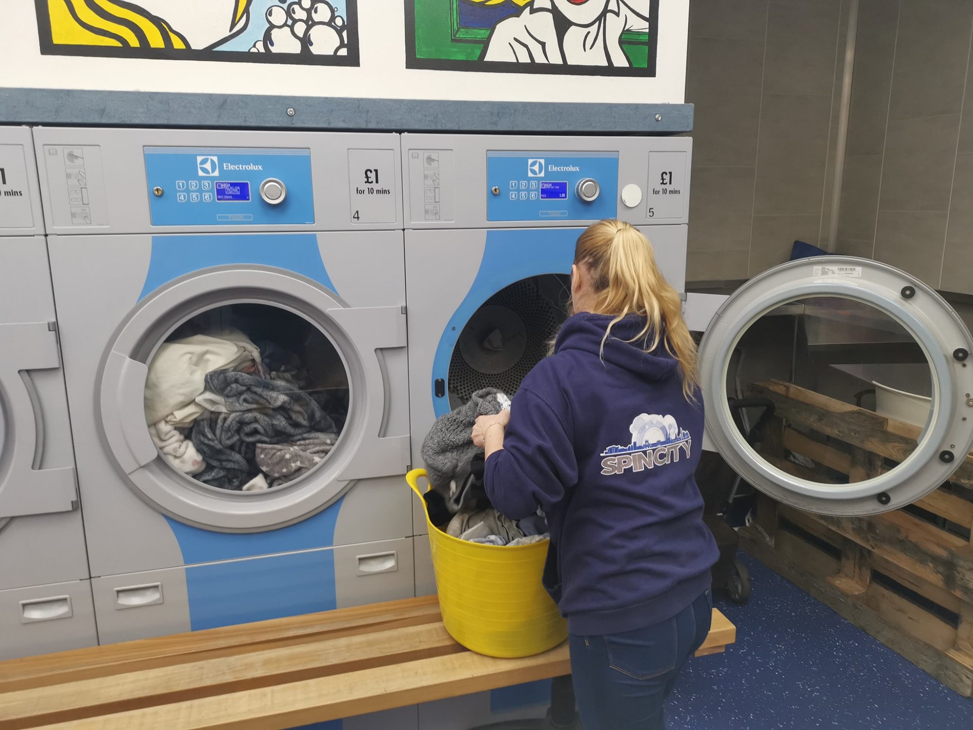 Man filling washing machine with clothes